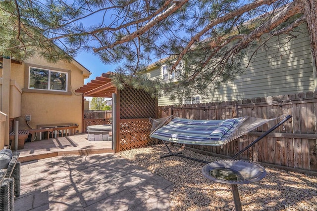 fenced backyard featuring a patio area and a deck