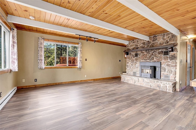 64 Elk Horn Ct, Bailey, CO 80421 - unfurnished living room with baseboards, wood finished floors, a baseboard heating unit, and beamed ceiling