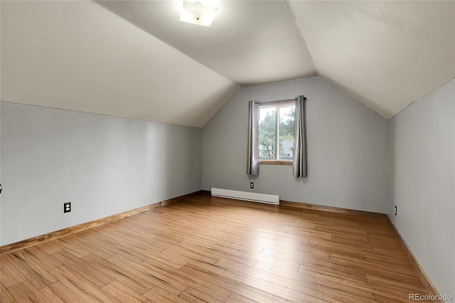 64 Elk Horn Ct, Bailey, CO 80421 - additional living space with baseboard heating, light wood-style floors, lofted ceiling, and baseboards