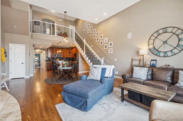 248 Writers Way, Colorado Springs, CO 80903 - living area featuring dark wood-style floors, stairs, a high ceiling, and recessed lighting