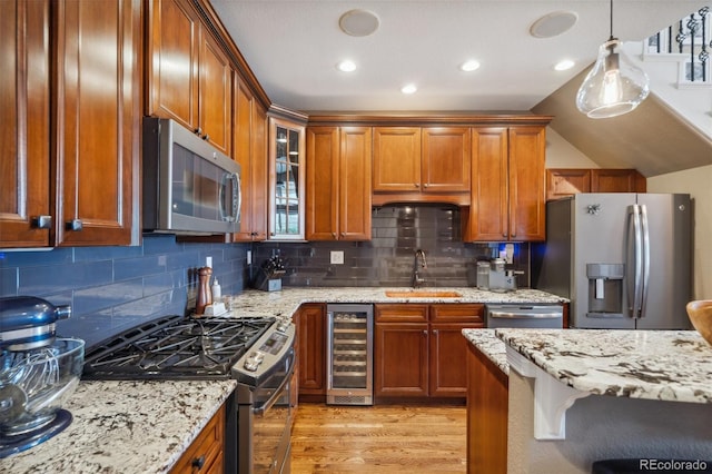 248 Writers Way, Colorado Springs, CO 80903 - kitchen featuring beverage cooler, appliances with stainless steel finishes, light wood-type flooring, light stone counters, and recessed lighting