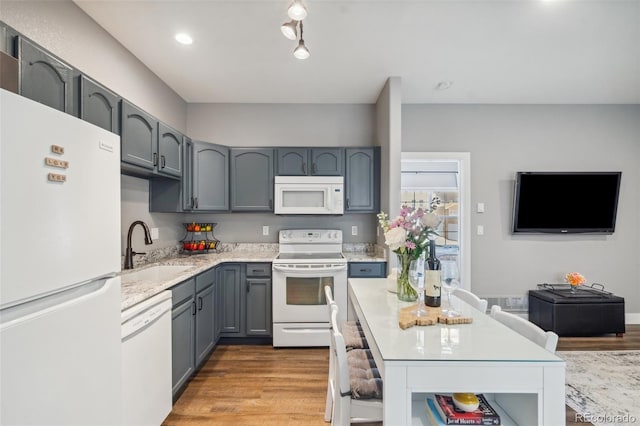 248 Writers Way, Colorado Springs, CO 80903 - kitchen with white appliances, gray cabinets, wood finished floors, and a center island