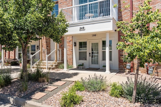 248 Writers Way, Colorado Springs, CO 80903 - view of exterior entry with brick siding and a balcony