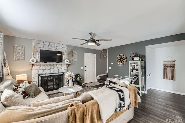 living room with ceiling fan, dark wood-type flooring, and a fireplace