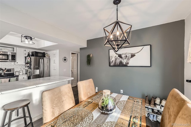 dining space with an inviting chandelier and hardwood / wood-style floors