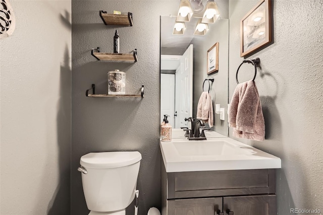 bathroom featuring toilet and vanity