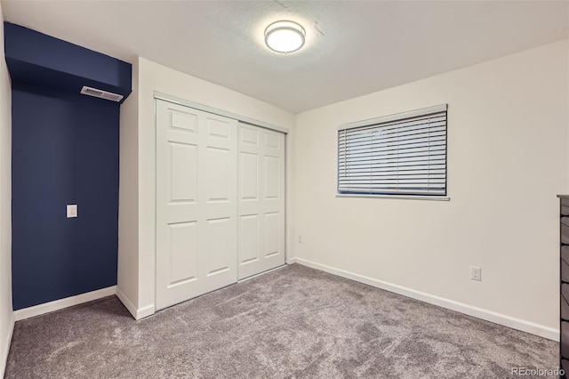 unfurnished bedroom with carpet and a closet