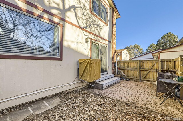 exterior space with cooling unit and a patio area