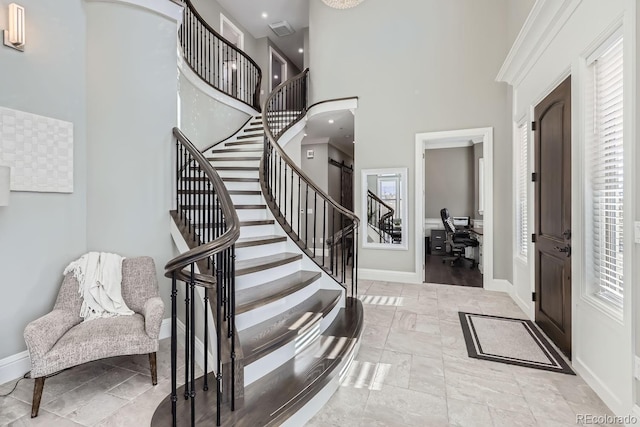 entrance foyer featuring a towering ceiling