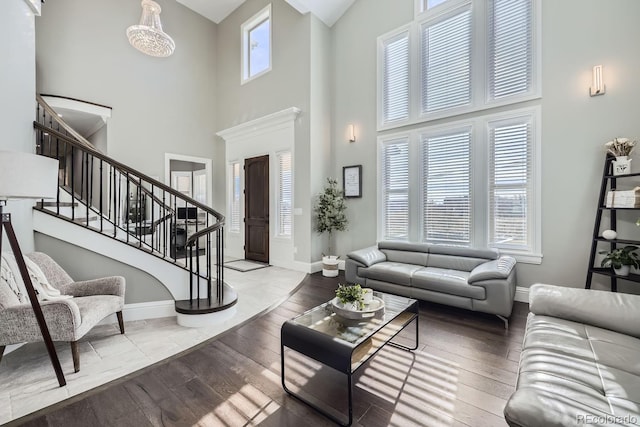 living room featuring hardwood / wood-style flooring and a towering ceiling