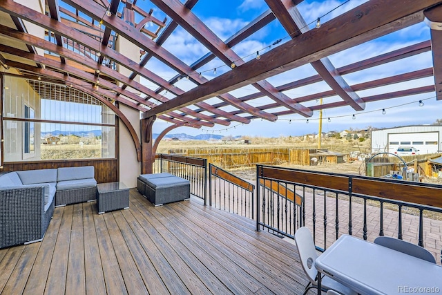 wooden deck featuring an outdoor living space and a pergola