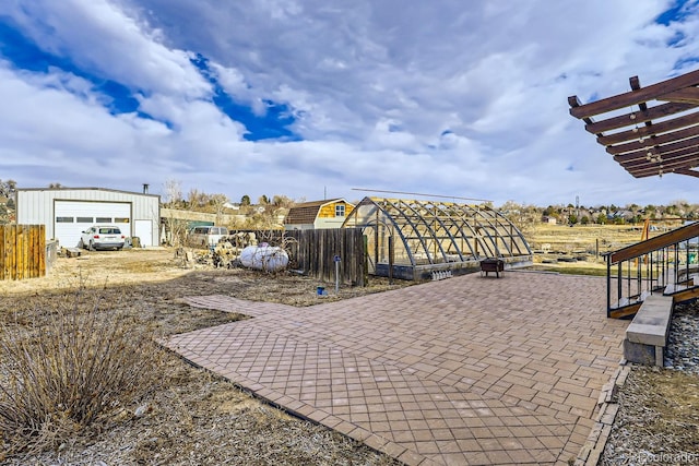 view of patio with a garage and an outdoor structure