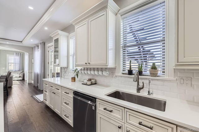 7587 Wright Ct, Arvada, CO 80005 - kitchen with stainless steel dishwasher, a sink, decorative backsplash, light countertops, and recessed lighting