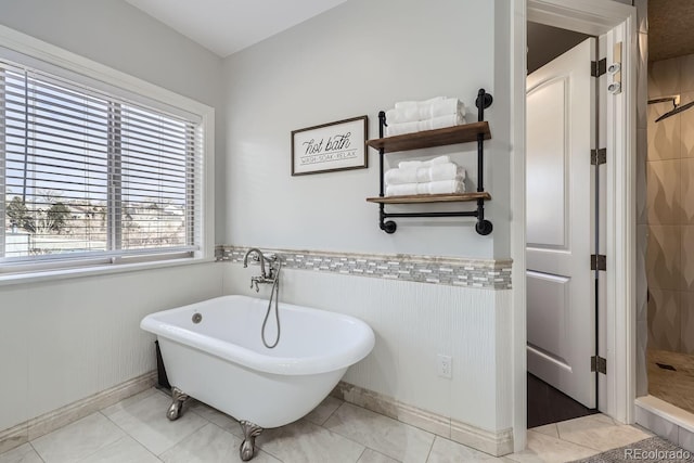 7587 Wright Ct, Arvada, CO 80005 - full bath featuring a shower stall, a soaking tub, wainscoting, and baseboards