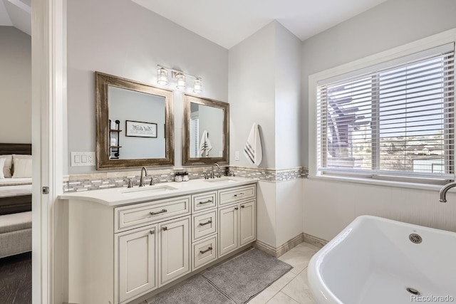 7587 Wright Ct, Arvada, CO 80005 - bathroom featuring double vanity, a freestanding bath, connected bathroom, and tile patterned flooring