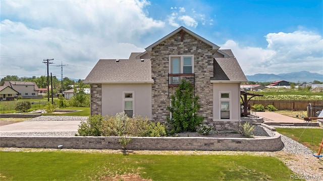 7587 Wright Ct, Arvada, CO 80005 - view of side of property with stone siding, stucco siding, and a shingled roof