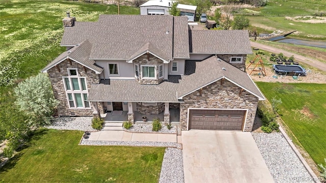 7587 Wright Ct, Arvada, CO 80005 - view of front of home featuring stone siding, roof with shingles, a chimney, a garage, and concrete driveway