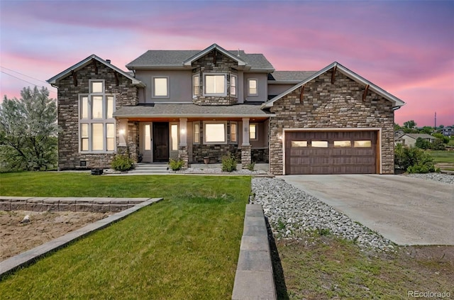 7587 Wright Ct, Arvada, CO 80005 - view of front of house featuring stone siding, driveway, a garage, and a lawn