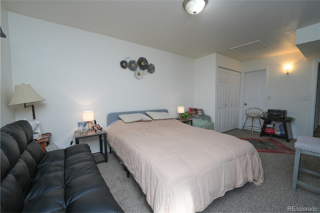 carpeted bedroom with a closet and attic access