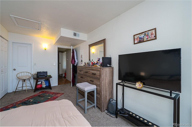 bedroom featuring attic access, carpet floors, and visible vents