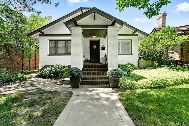 635 Fillmore St, Denver, CO 80206 - view of front facade featuring a chimney and brick siding