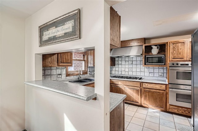 kitchen with extractor fan, light tile patterned flooring, tasteful backsplash, sink, and stainless steel appliances