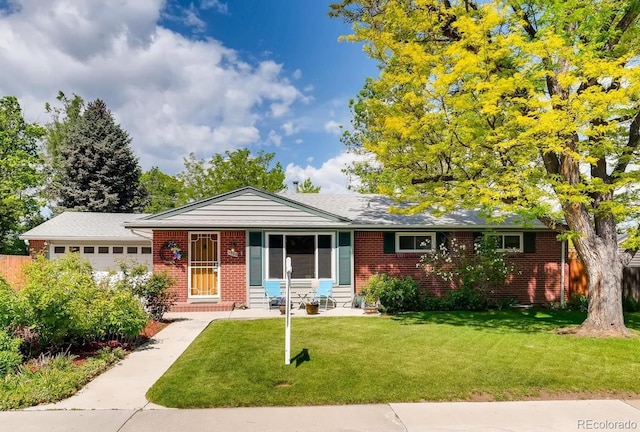 single story home with a garage and a front lawn