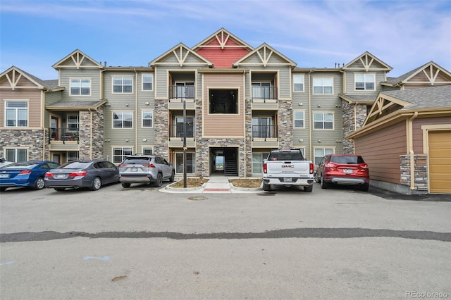 view of front of home featuring a balcony and a garage