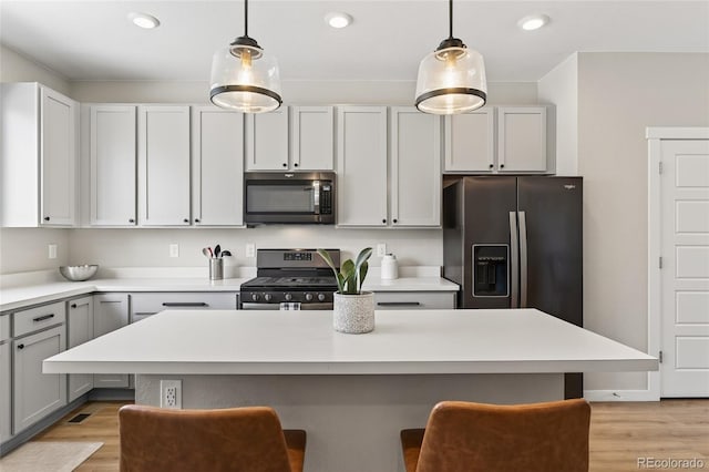 5396 Quail St, Wheat Ridge, CO 80033 - kitchen with stainless steel appliances, a kitchen breakfast bar, light countertops, and recessed lighting