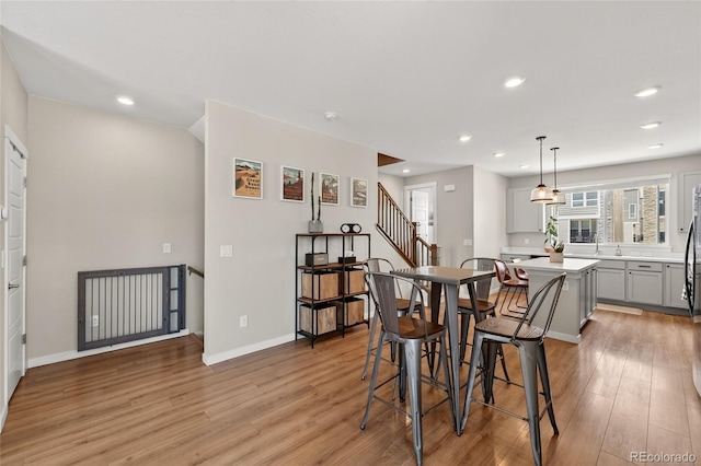 5396 Quail St, Wheat Ridge, CO 80033 - dining space featuring light wood-style floors, recessed lighting, and stairs