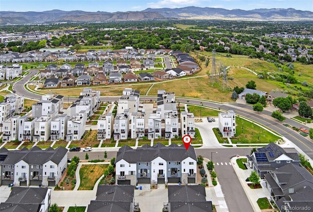 5396 Quail St, Wheat Ridge, CO 80033 - aerial overview of property's location with a mountain backdrop and nearby suburban area