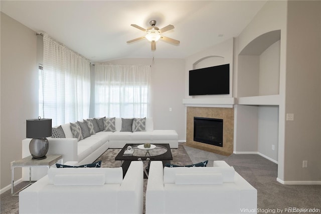 carpeted living room featuring ceiling fan and a fireplace