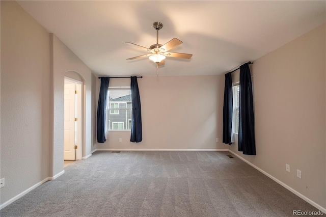 empty room featuring carpet flooring and ceiling fan