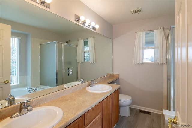 full bathroom featuring separate shower and tub, toilet, vanity, and hardwood / wood-style flooring