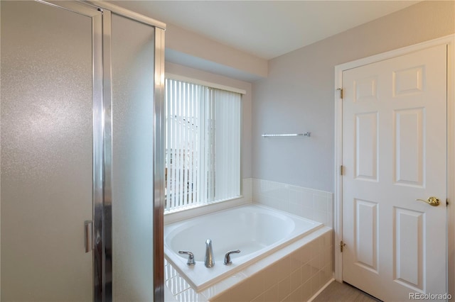 bathroom featuring separate shower and tub