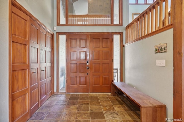 foyer entrance featuring a towering ceiling