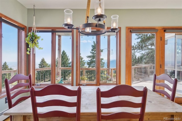 sunroom / solarium with an inviting chandelier