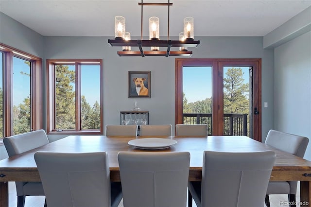 dining area with a wealth of natural light and a notable chandelier