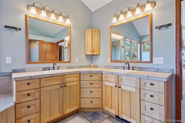 bathroom with vanity and lofted ceiling