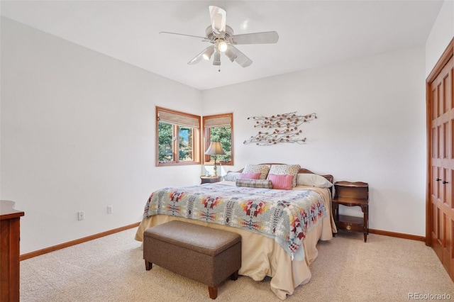 bedroom with light carpet and ceiling fan