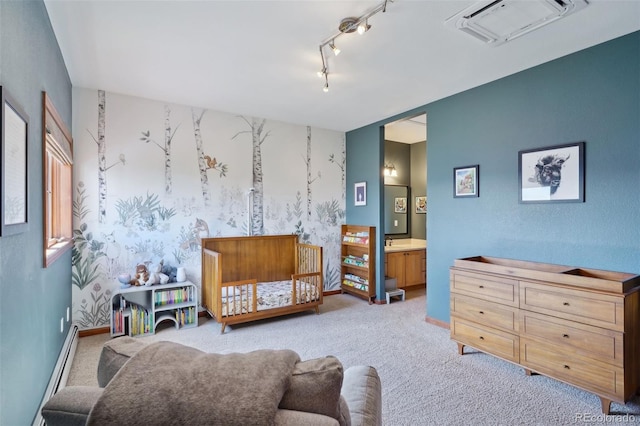 living area featuring light carpet, rail lighting, and baseboard heating