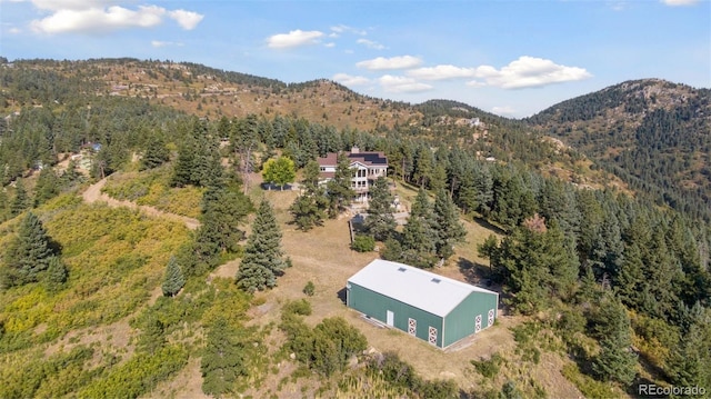 12421 High Country Trl, Littleton, CO 80127 - drone / aerial view of a heavily wooded area and a mountainous background