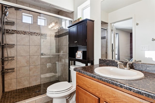 bathroom featuring vanity, tile patterned floors, toilet, and walk in shower