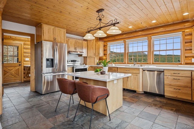 kitchen with light countertops, stainless steel appliances, under cabinet range hood, a kitchen island, and wood ceiling