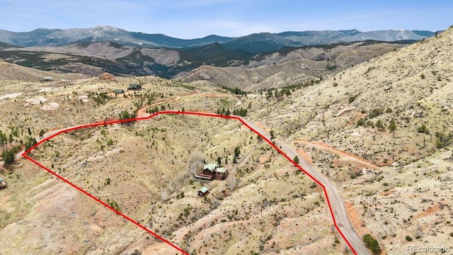 drone / aerial view featuring a mountain view and a rural view