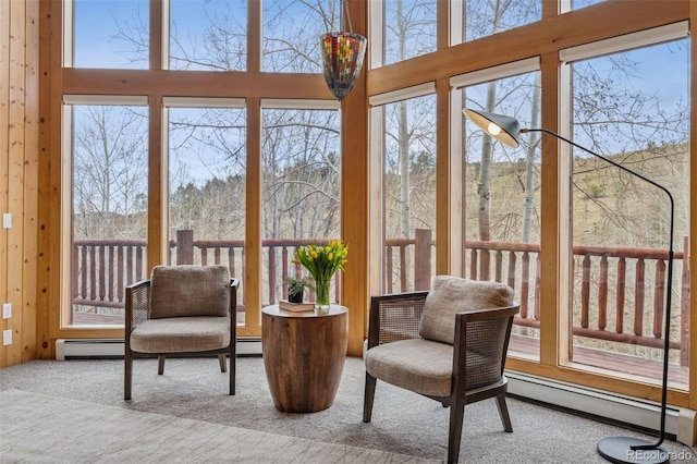 sunroom / solarium featuring baseboard heating and a wealth of natural light
