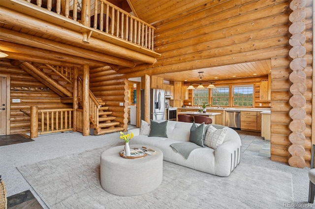 living area with light colored carpet, log walls, wooden ceiling, and stairway