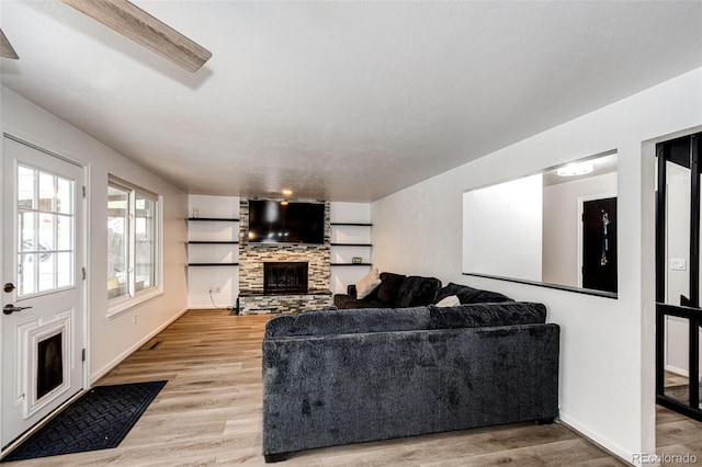 7840 W Portland Ave, Littleton, CO 80128 - living room with a fireplace and light wood finished floors