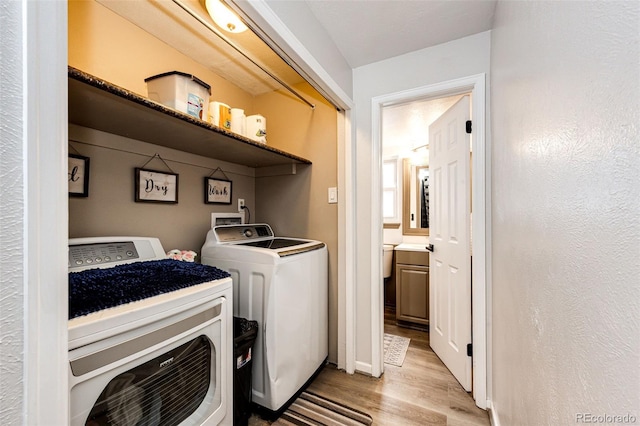 7840 W Portland Ave, Littleton, CO 80128 - laundry area with light wood finished floors and washing machine and clothes dryer