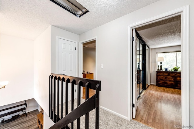 7840 W Portland Ave, Littleton, CO 80128 - corridor with a textured ceiling and an upstairs landing